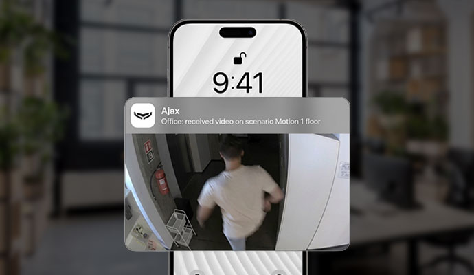 Smartphone receiving a real-time motion detection alert notification with video snapshot.