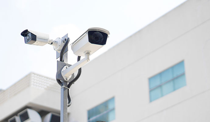 Outdoor commercial bullet security cameras installed on an exterior pole