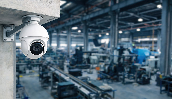 Security camera installed on a concrete pillar inside an industrial facility