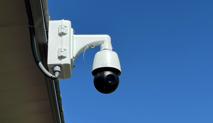 An installed PTZ camera mounted on a fascia soffit