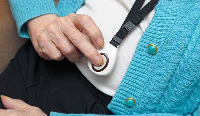Person using an emergency medical alert pendant button