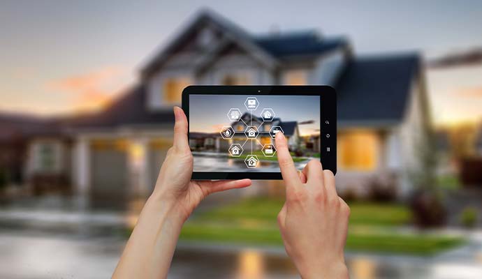Person using a tablet to control a connected smart home security system