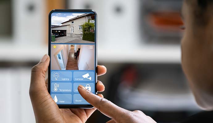 Person monitoring 24/7 home security camera feeds to manage security